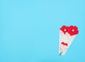 The flowers made of felt hearts wrapped in a white lace bundle on blue background. MotherÃ¢â¬â¢s day, ValentineÃ¢â¬â¢s day, Wedding,